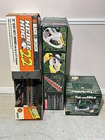 Boxes for Black & Decker Hedge Hog trimmer and Turtle Wax polisher alongside blade of Black & Decker unit