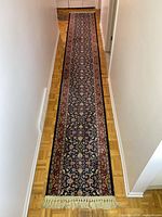 Full length view of the floral runner laid in hallway showing overall pattern and colors