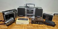 All five electronic items arranged together on floor