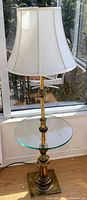 Full view of Stiffel brass and glass floor lamp with shade and shelf