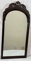 Front view showing carved walnut frame and mirror glass
