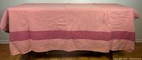 Full view of blanket draped over surface showing overall color and stripe