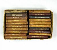 Top view of all 20 miniature volumes in slipcase showing spine titles and wear