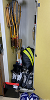Closet view showing wooden racquets, racquet bags, skates