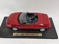 Top view of red Alfa Romeo Spider diecast on display base
