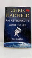 Front cover of hardcover book showing title and astronaut image