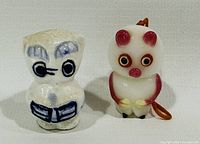 Front view of both cat figurines showing design and colors