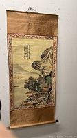 Full view of hanging scroll showing artwork, borders, top hanging cord and bottom roller