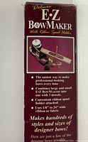 Front of retail box for Deluxe E-Z BowMaker showing product image and features