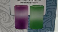 Package graphics showing purple and green examples of flameless candles