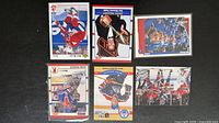 All six trading cards laid out for overview