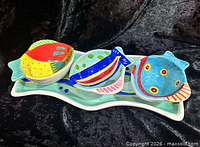 Tray with three multicolor fish bowls displayed