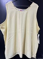 Front view of light yellow Alia sleeveless top with tag