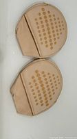 Two beige toe pads showing dotted silicone grip pattern