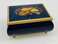 Top view showing marquetry mandolin motif, cobalt blue finish, gold-tone feet