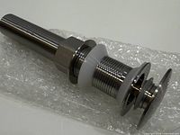 Complete stainless steel sink drain assembly on bubble wrap