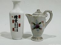 Front view of porcelain vase and floral teapot