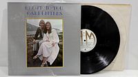 Album cover front with vinyl partially removed from inner sleeve