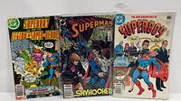 Front view of three bagged DC comic books: Superboy and the Legion of Super-Heroes, Superman Skyhooked, The New Adventures of Superboy