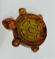 front view of amber and green glass turtle-shaped soap dish
