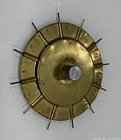 Front view of brass Daisy Knitter showing pins and central post