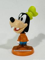 Front view of Goofy figurine on orange base