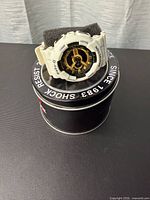 Front view of white Casio Baby-G G-Shock watch on tin case