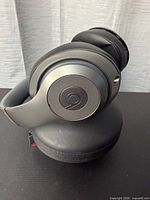 Left view of Beats Studio headphones resting on case