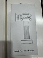 Front of sealed box showing line drawing and product name Electric Foot Callus Remover