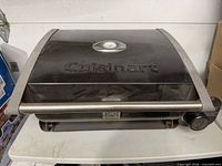 Front view of closed Cuisinart portable grill, lid thermometer visible