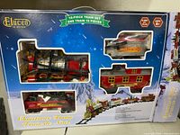 Front of boxed Eluceo 16-piece Christmas Train Set showing contents through window