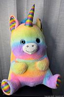 Front view of rainbow pastel plush unicorn