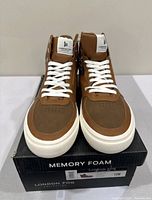 Front view of cognac high-top sneakers on box