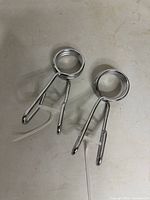 Two chrome spring collars lying flat