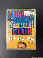 Front view of plastic case with Topps Stadium Club 1996-97 NBA Basketball Series 1 insert card visible