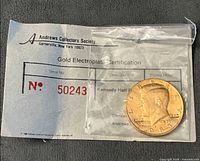 Certificate with coin partially visible