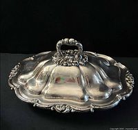 entire dish with lid on, showing ornate border and overall shape