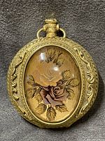 Front view showing floral cabochon and gilt frame