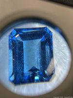 Close-up through loupe showing cut and inclusions