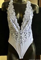 Front view of lavender lace bodysuit on mannequin