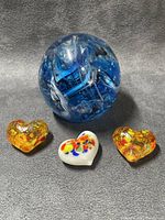 Blue glass paperweight sphere with three heart accents