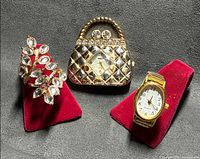 All three items: handbag watch, ring watch on stand, leaf ring on stand