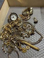 Overview of mixed gold-tone jewellery and watches in box