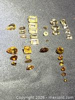 Overall view of all 33 citrine stones grouped by shape and size