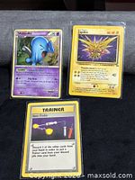 Overall view of the three sleeved Pokémon cards