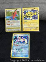 Front view of all three Pokémon cards in sleeves