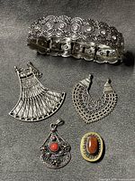 group shot of bracelet and four pendants