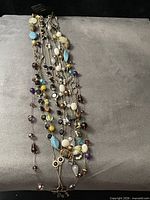 All necklaces draped on display showing bead variety and strand layers