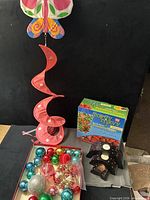 Lot overview showing spiral decoration, planter box, ornaments and stacked candle holders