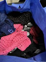 Open bag showing assorted clothing fabrics
